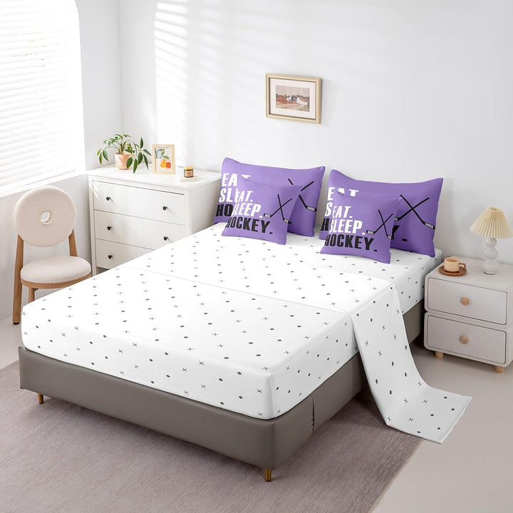 White fitted sheet and purple hockey pillowcases