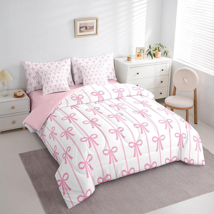 Pink bow twin comforter and pillow covers on bed
