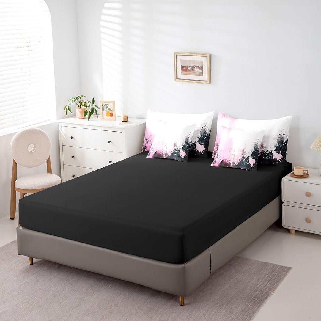 Black sheet and matching pink abstract pillows