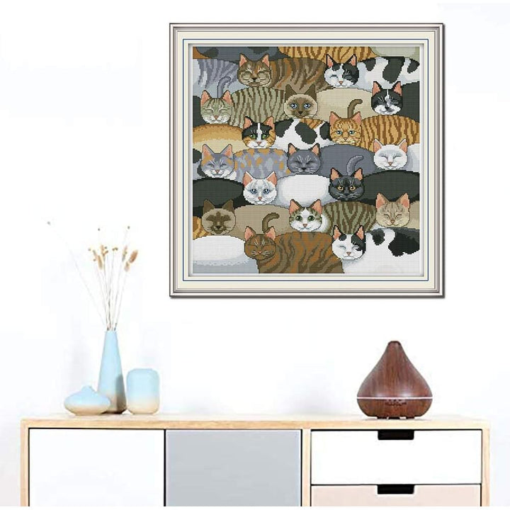 Cats cross-stitch artwork shown framed for display; frame not included