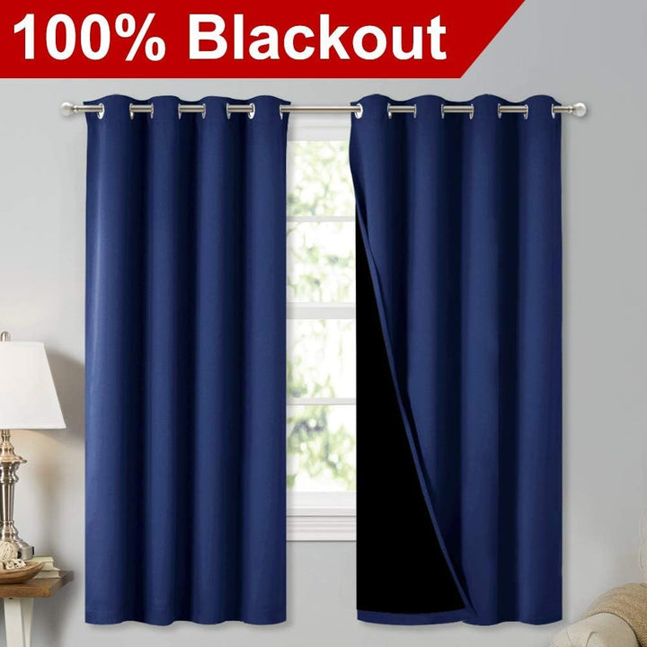 Dark Blue blackout grommet curtain panels on a window