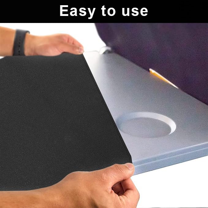 Black travel cover fitted over an airplane tray table