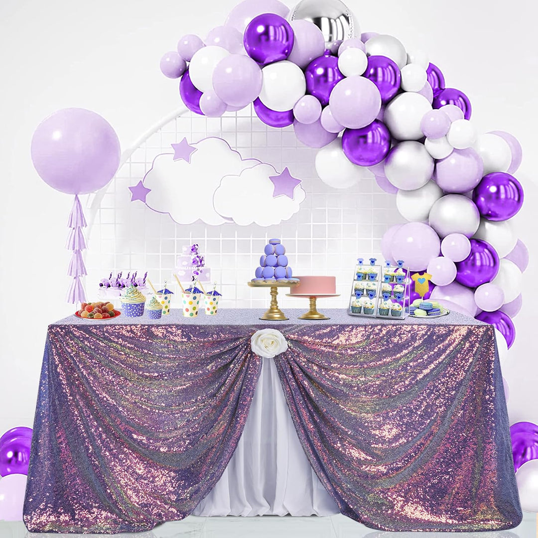 Rainbow purple tablecloth draped on dessert table