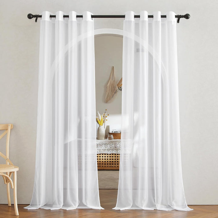 White sheer 54 by 84 inch two-panel curtains installed