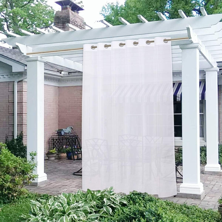 White sheer outdoor curtain panel on patio pergola