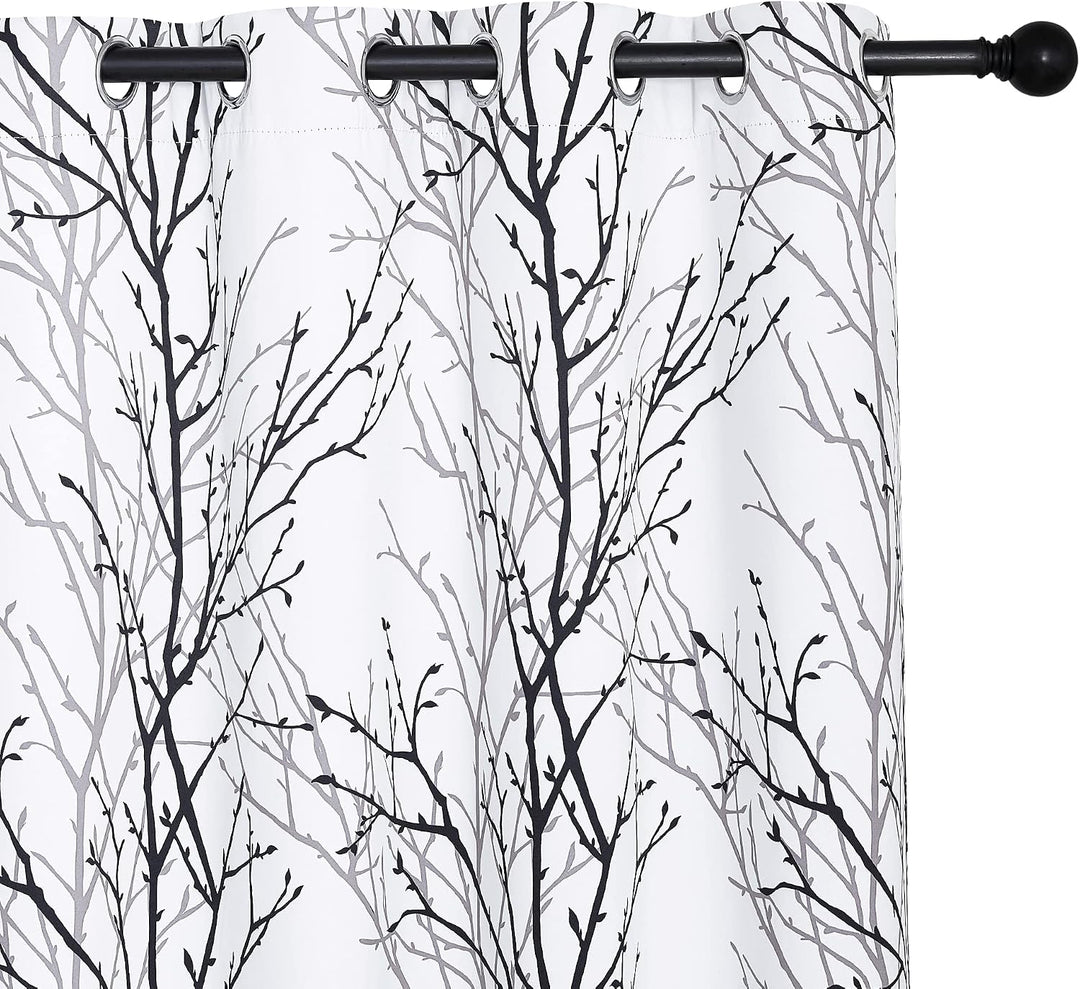 Black and grey branch-print curtain grommets and pattern detail