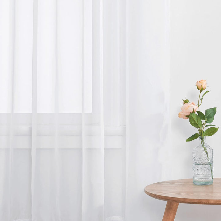 White sheer curtain pair room view