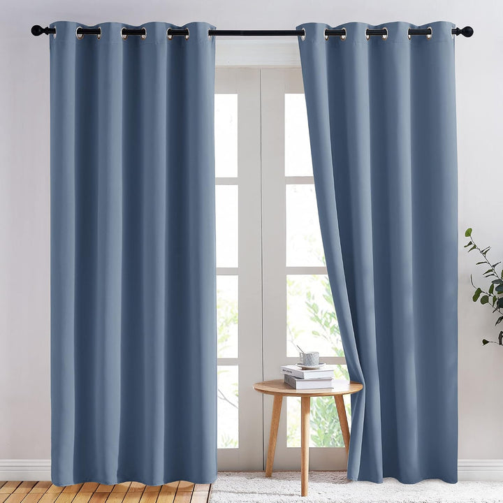 Stone Blue 52 by 84 inch blackout grommet curtain styled as a window pair; one panel included