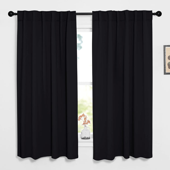 Black 52 by 63 inch back-tab blackout curtain pair on window