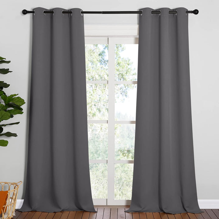 Grey two-panel grommet curtains hanging at a window