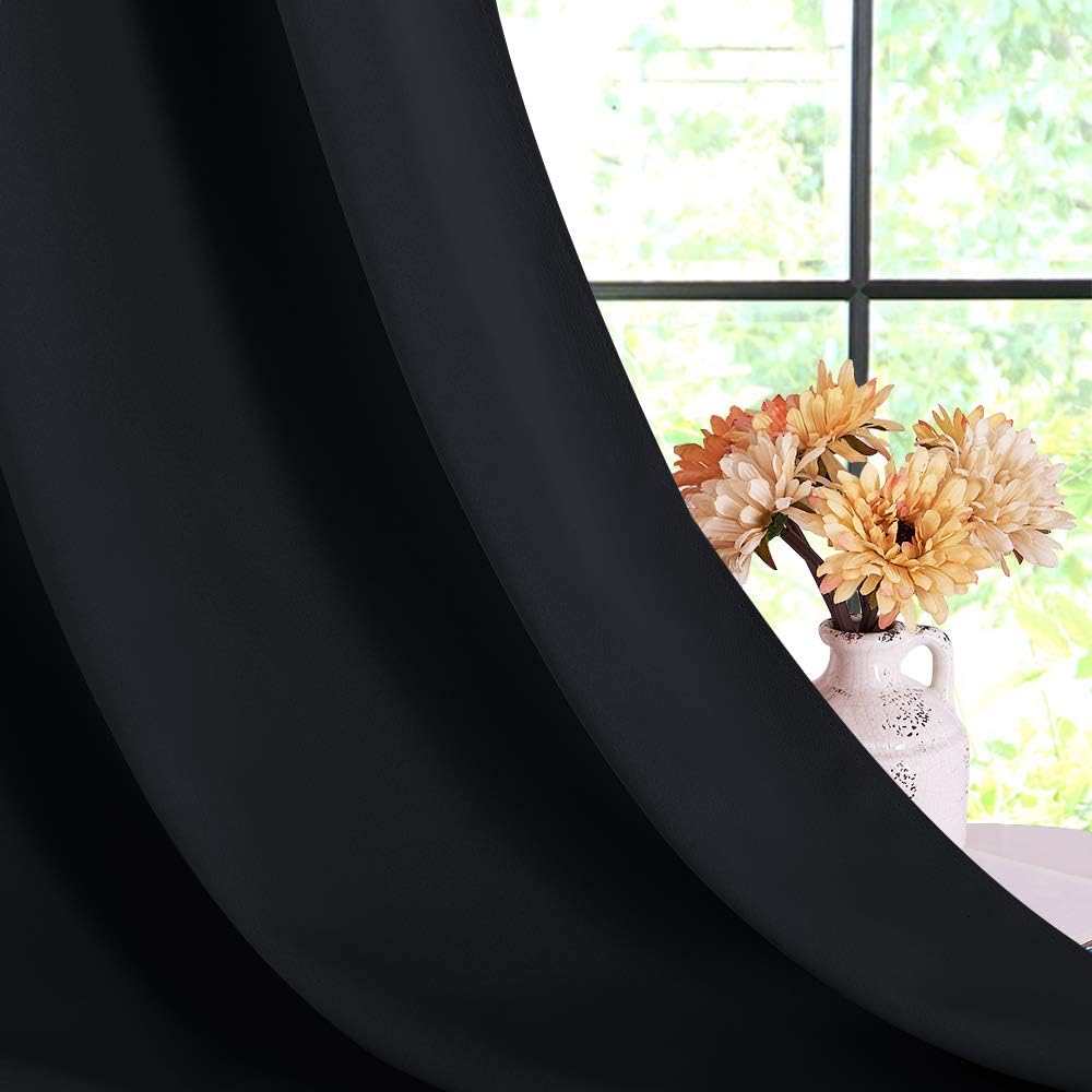 Black curtain draped by a window