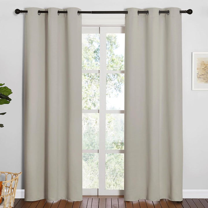 Natural two-panel grommet curtains hanging at a window