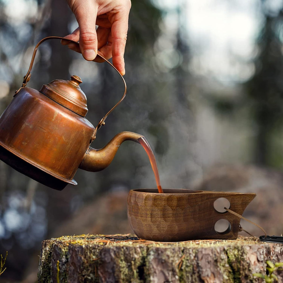 Single 240 mL wooden camping cup with double-hole handle in use